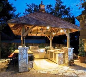 Nightime shot of outdoor kitchen with roof